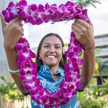 A visitor receives a flower lei during a Hawaiian welcome.