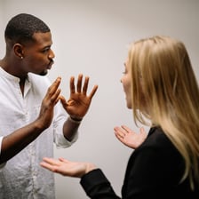 Two people in an argument representing clashing egos