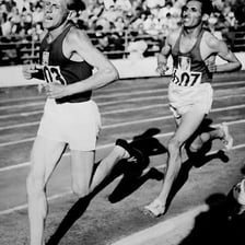 Black-and-white image of distance runner Emil Zátopek competing.
