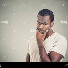 A person with a visibly sad expression looking downward