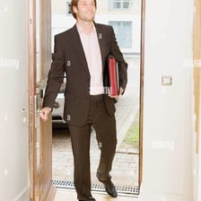 A person arriving at a doorway