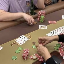 Poker chips being placed into the center of a table