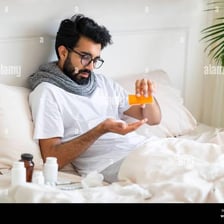 A sick person taking medication.