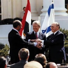 Diplomats signing a formal treaty.