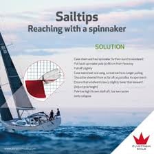 Sailors working together to handle a spinnaker and jib on a sailboat.