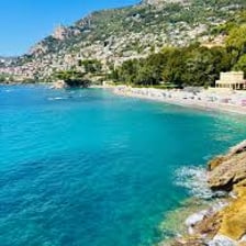 A busy summer beach scene on the Côte d’Azur