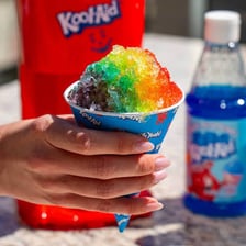 Brightly colored snow cones topped with flavored syrup