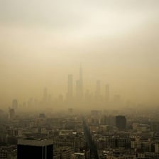 A city skyline obscured by a layer of smog.