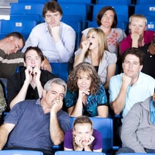 An audience member yawning during a dull presentation