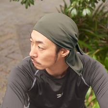 A person wearing a close-fitting durag head covering.