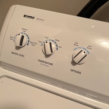 Clothes being rinsed with water inside a washing machine.