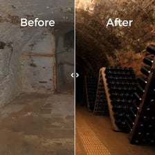 A dim basement with visibly damp walls and condensation