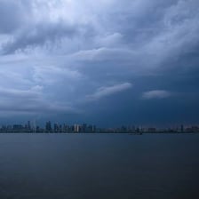 Dark storm clouds appearing ominously over a city