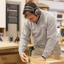 A craftsperson performing a task with precise skill