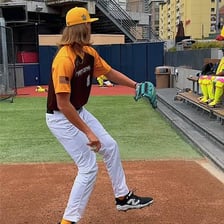A baseball pitcher delivering a very fast pitch