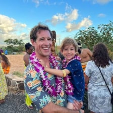 Outdoor Hawaiian luau with food and entertainment near a beach