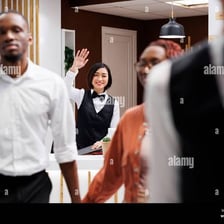 A person gesturing for someone not to leave