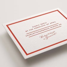 An invitation beside an RSVP response card