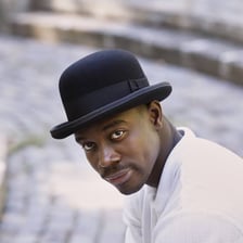 A bowler hat resting on a person’s head.