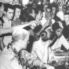 A 1960s civil-rights sit-in protest with demonstrators seated together.