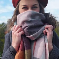 A person wearing a warm scarf outdoors in winter.