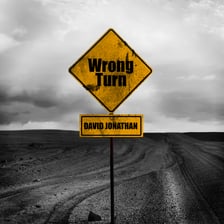 A traveler facing a sign indicating a wrong turn