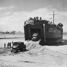 A World War II Landing Ship, Tank approaching a beach