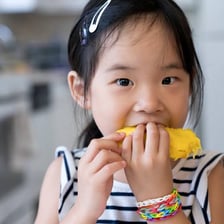 A person eating a mango