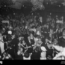A crowd celebrating New Year’s Eve while singing together.