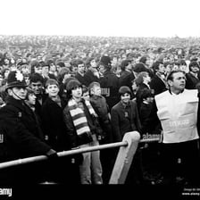 A crowd moving forward in a sudden surge.