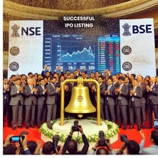A company representative ringing a stock-exchange bell for an IPO