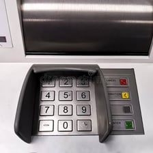 Close-up of an ATM keypad with an Enter key