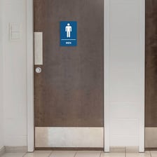 A restroom door bearing a MEN sign