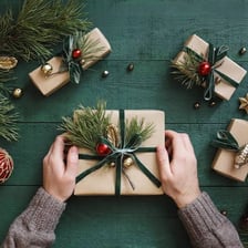 A person unwrapping a Christmas present