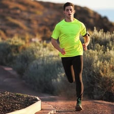 A runner moving quickly along a track.