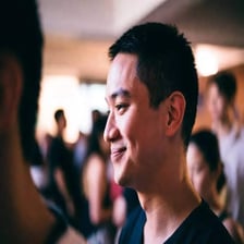 A person making a quiet, restrained laugh