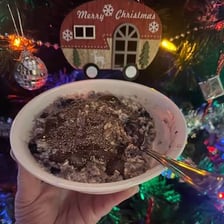 A bowl of thick, lumpy overcooked oatmeal.