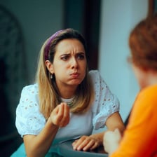 A person reacting to a painful bump