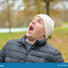 A person staring with an open mouth in visible amazement.