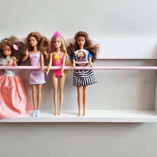 A doll displayed on a toy store shelf.