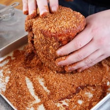 Dry barbecue spices rubbed onto a piece of meat