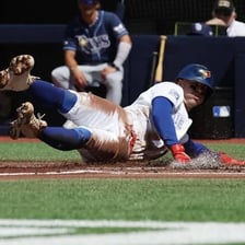 A baseball player sliding into third base.