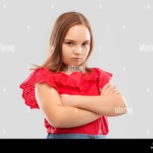 A person standing with crossed arms and a visibly pouting expression.