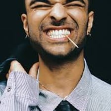 Person displaying a small, self-satisfied smirk