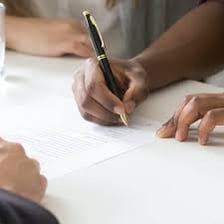 A person holding a document representing property ownership.
