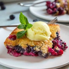 A fruit pie displayed beside a fruit cobbler.