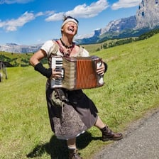 A singer yodeling in an Alpine mountain landscape.