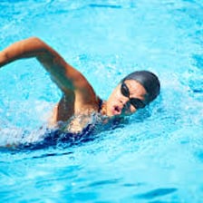 A swimmer moving through a lane in a pool.