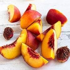 A nectarine showing its smooth red-and-yellow skin.