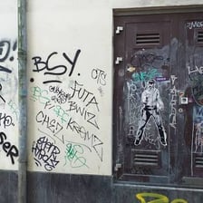 A stylized graffiti signature painted on a wall.